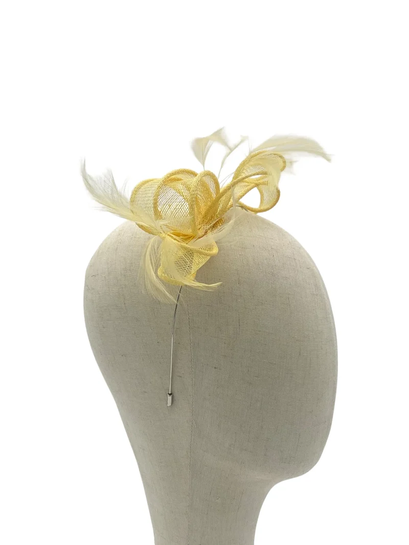 Dainty lemon minimalist sculptural fascinator with looped sinamay, front view on a mannequin head
