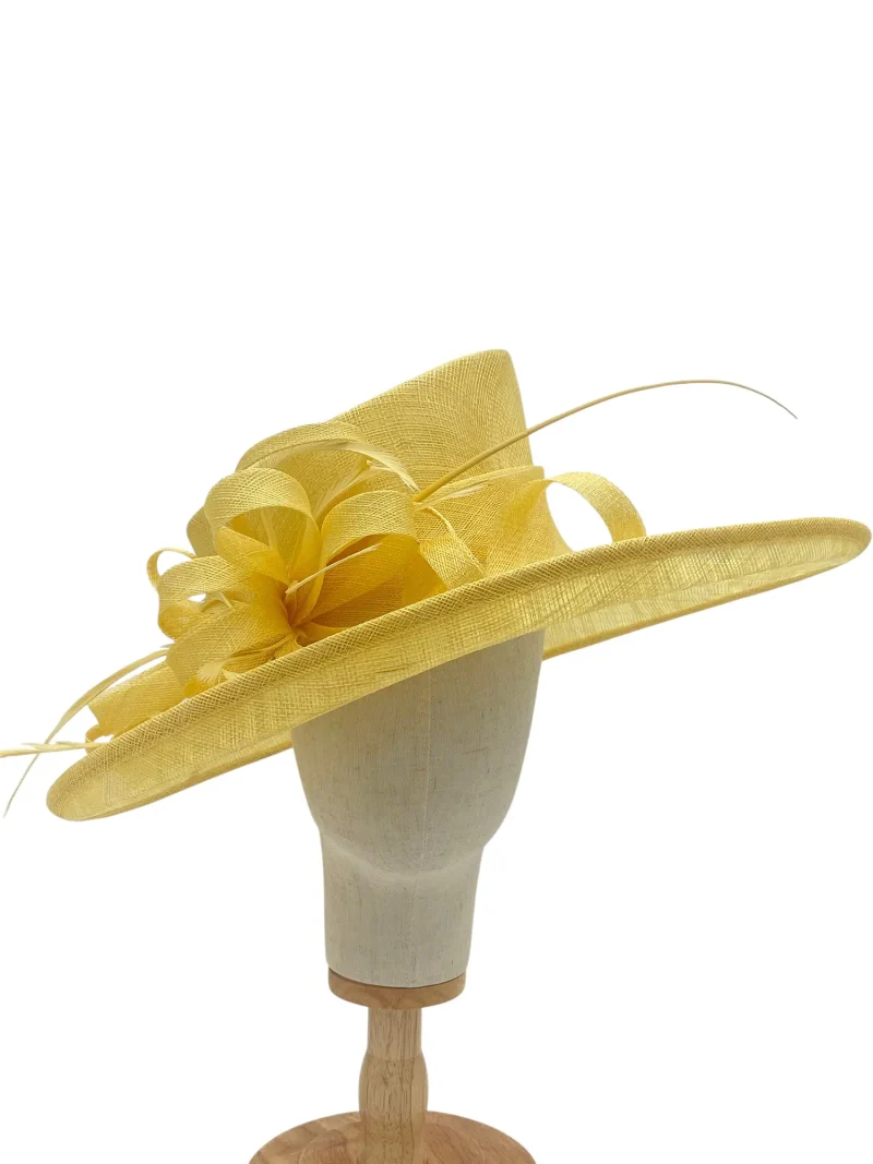 Large lemon statement wedding hatinator with wide brim and feathers, three-quarter view on a mannequin head