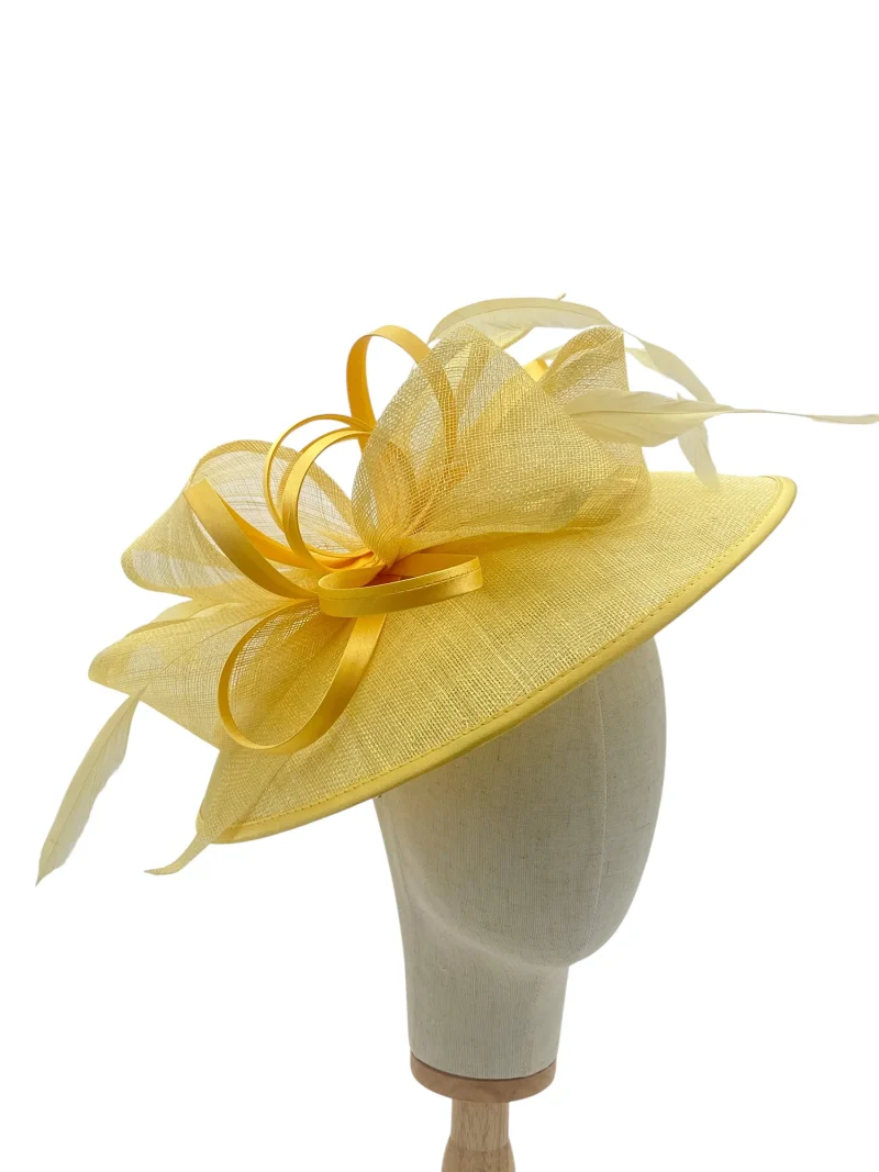 Lemon large saucer hatinator with sinamay bow, three-quarter view on a mannequin head