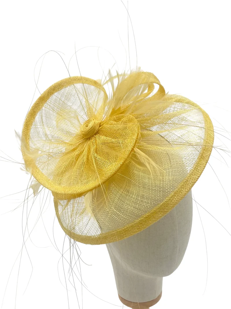 Lemon tiered saucer hatinator with looped sinamay centre, near-front view on a mannequin head