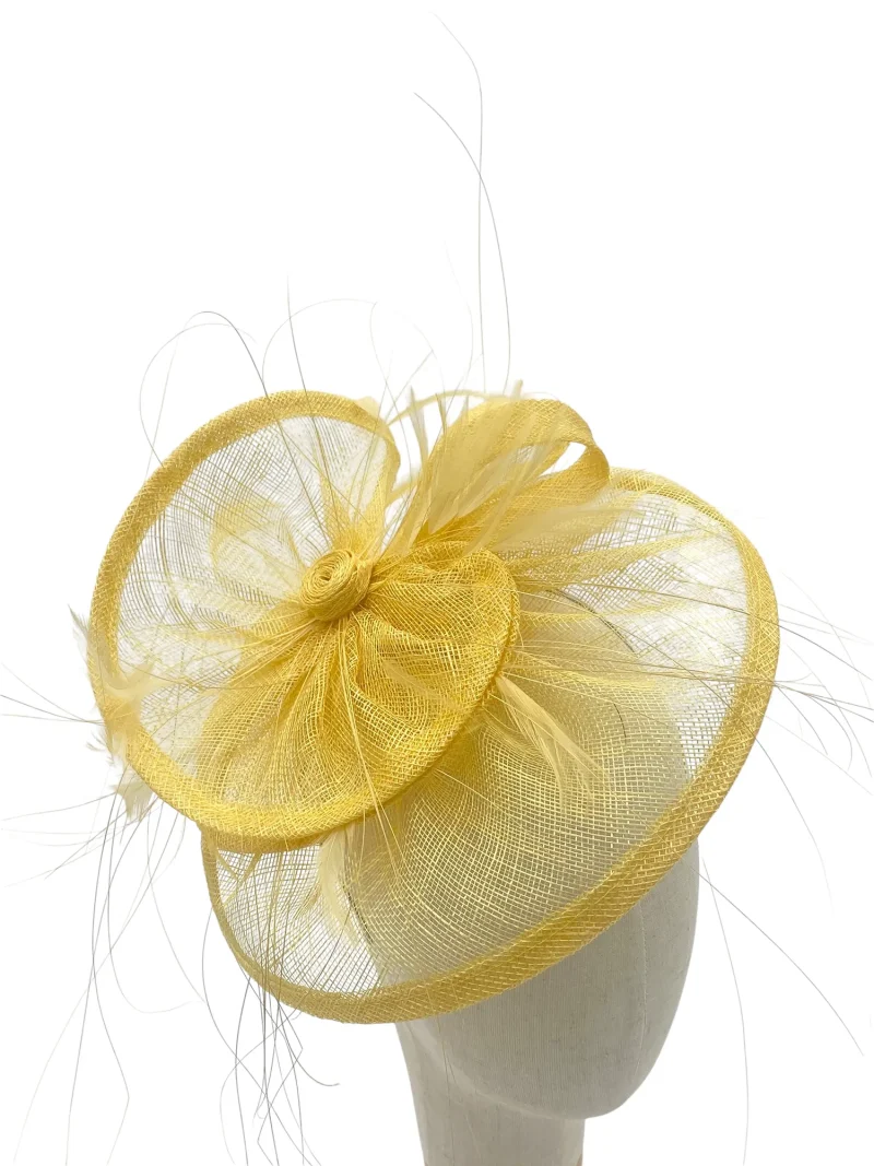 Lemon tiered saucer hatinator with layered sinamay, angled view on a mannequin head