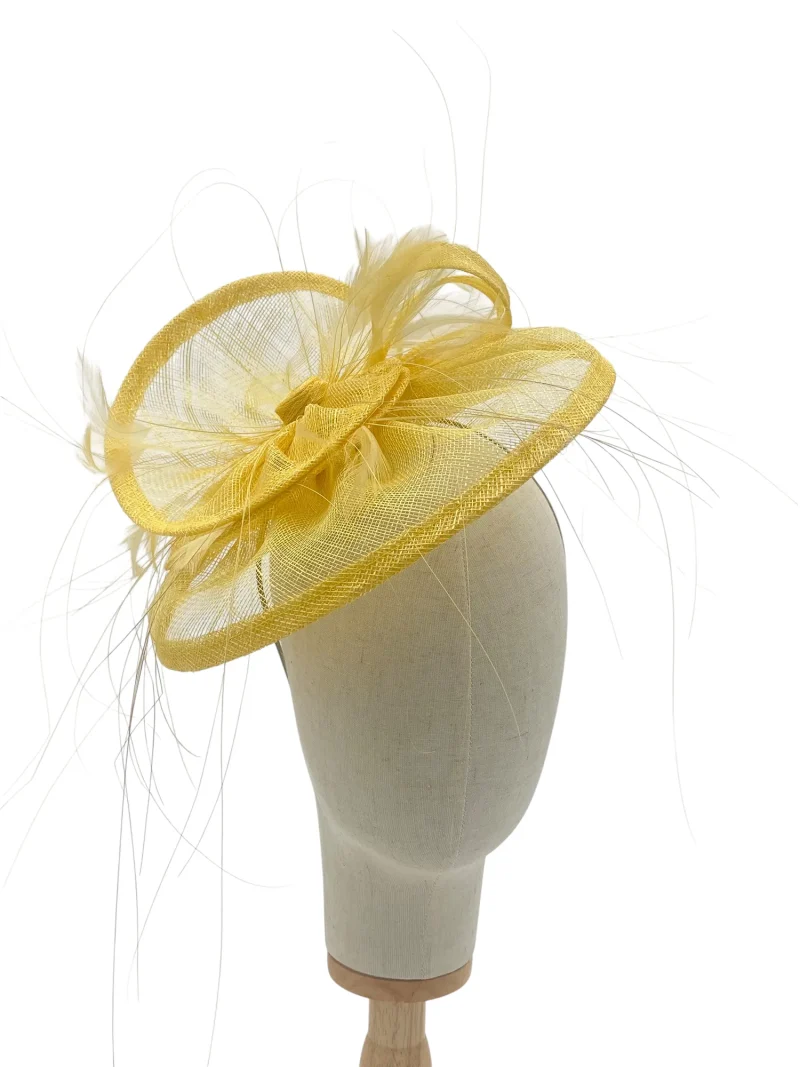 Lemon tiered saucer hatinator with feathers, front-angle view on a mannequin head