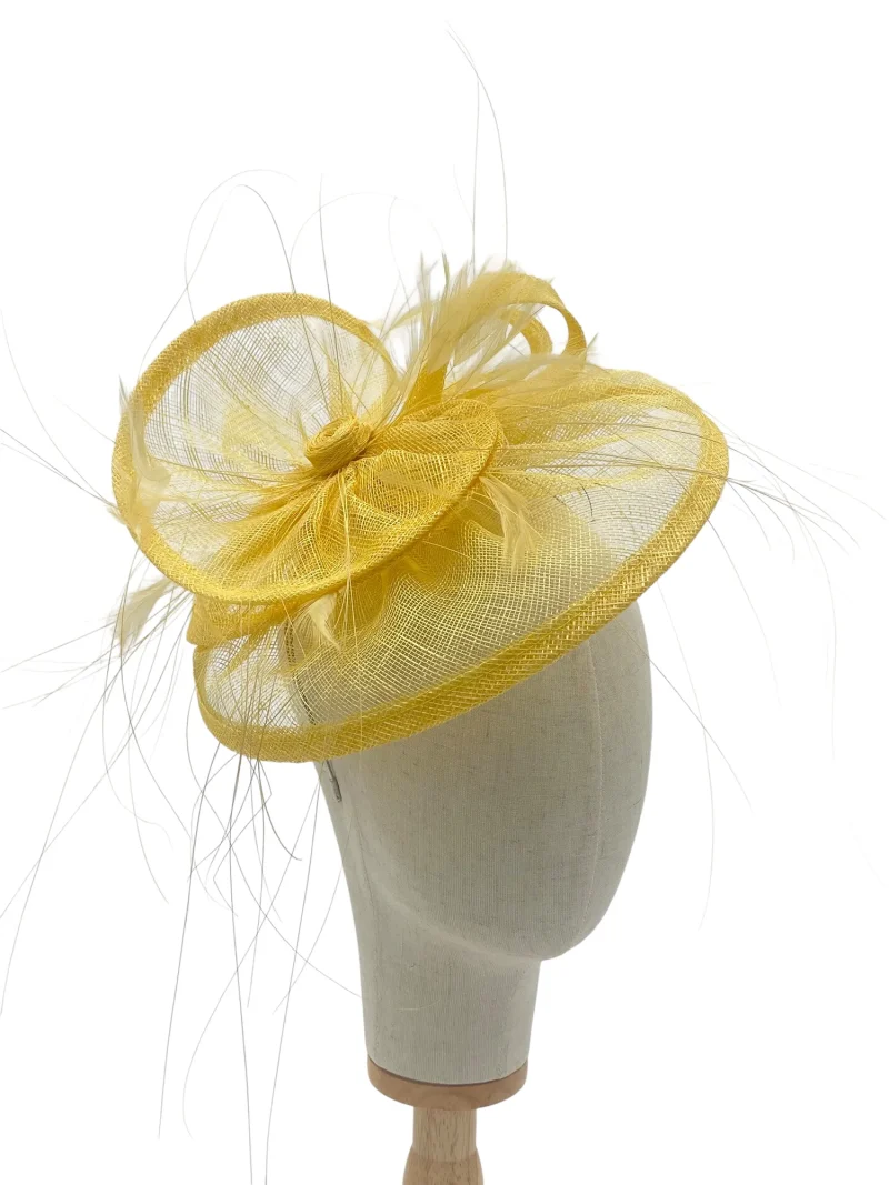 Lemon tiered saucer hatinator with fine feather burst, three-quarter view on a mannequin head