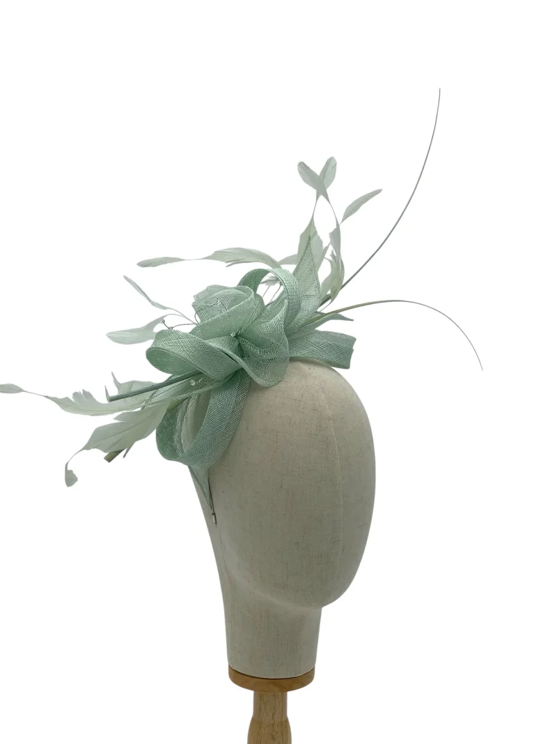Aqua sinamay wedding or races fascinator with looped sinamay and feather spray, three-quarter view on a mannequin head