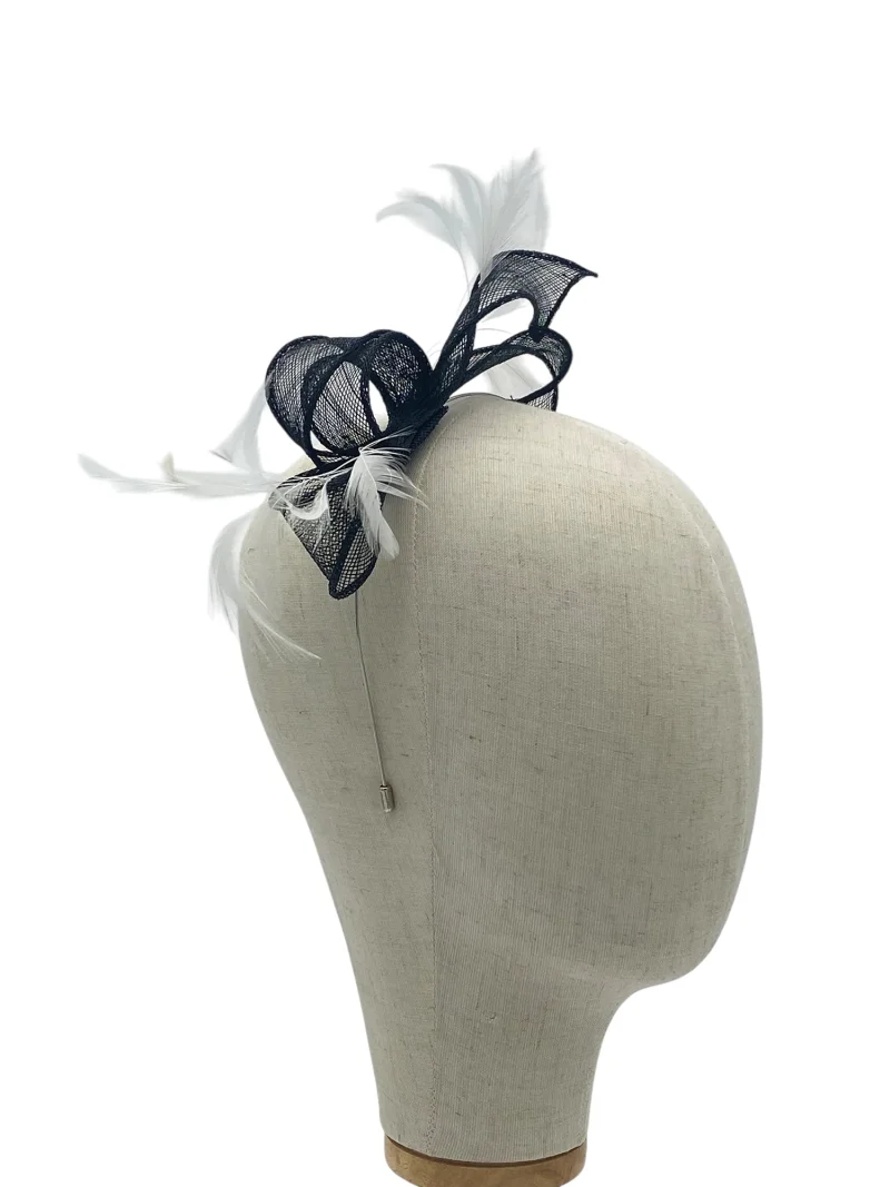 Dainty black and white minimalist sculptural fascinator with sinamay detail and feather quills, side three-quarter view on a mannequin head