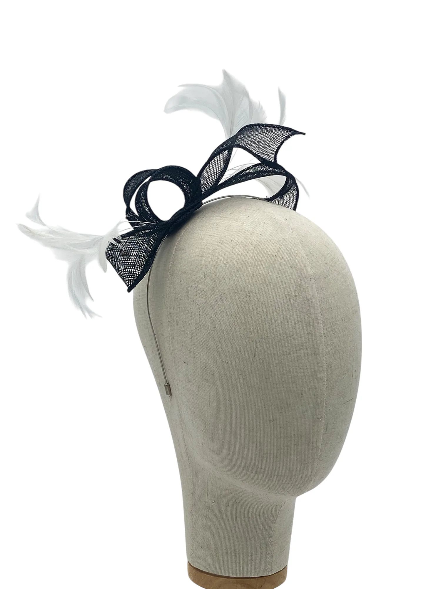 Dainty black and white minimalist sculptural fascinator with sinamay loops and feathers, three-quarter view on a mannequin head