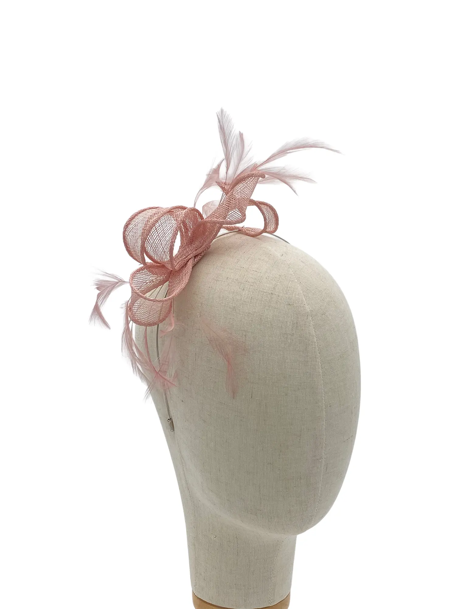 Beige mannequin head wearing a pink fascinator with netted bow and feathers on top