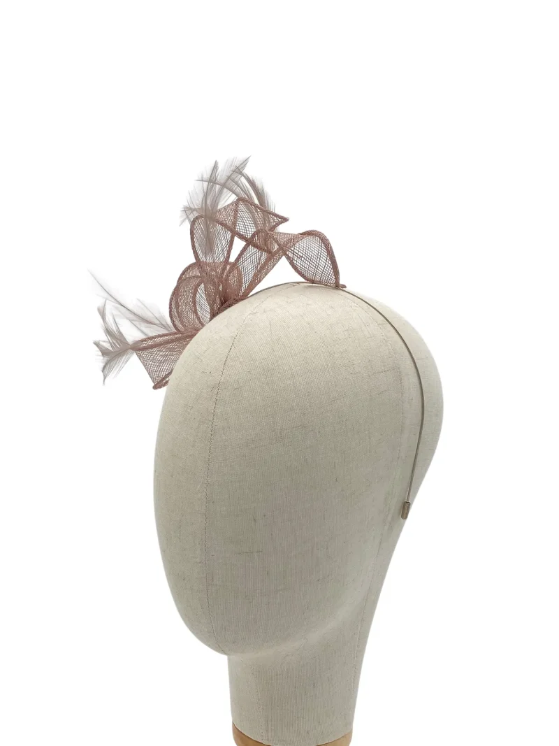 Beige dress hat with decorative pink mesh bow and feather accents shown on a mannequin head